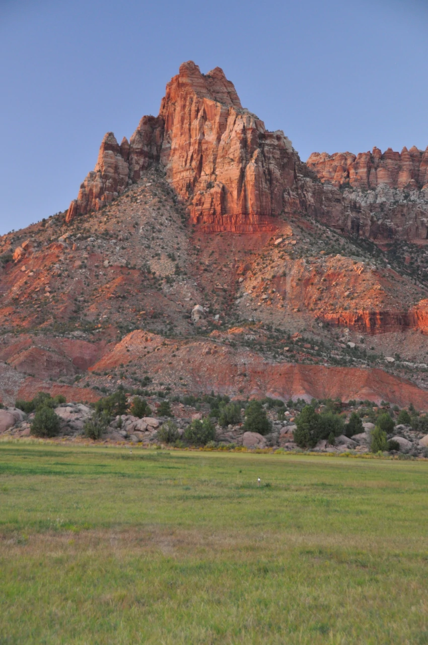 MRG red rock mountain with green field at golden hour