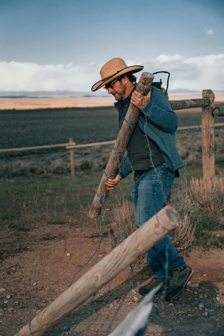 MRG team member fixing fence on ranch land