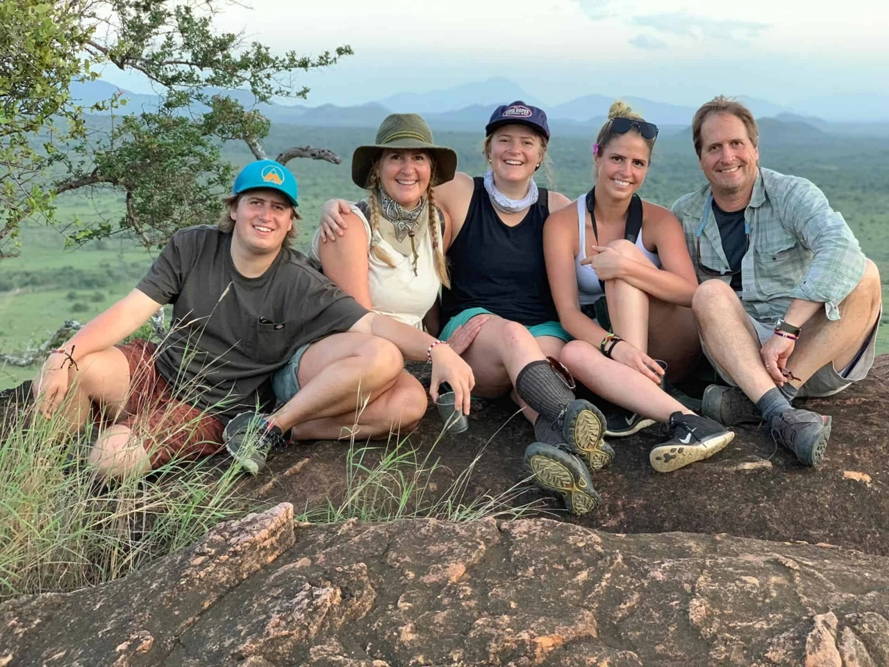 Ken Mirr and family relax together on a scenic mountaintop